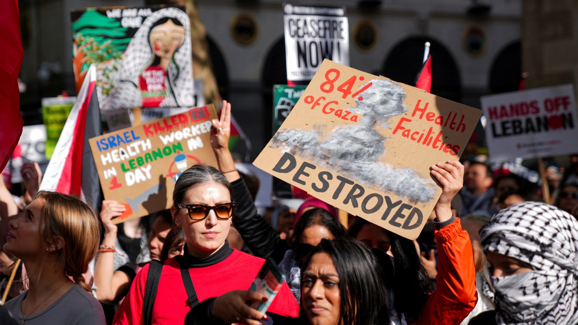 Protesters carry placards during a demonstration calling for a ceasefire in Gaza, in London, 5 October  (Reuters)