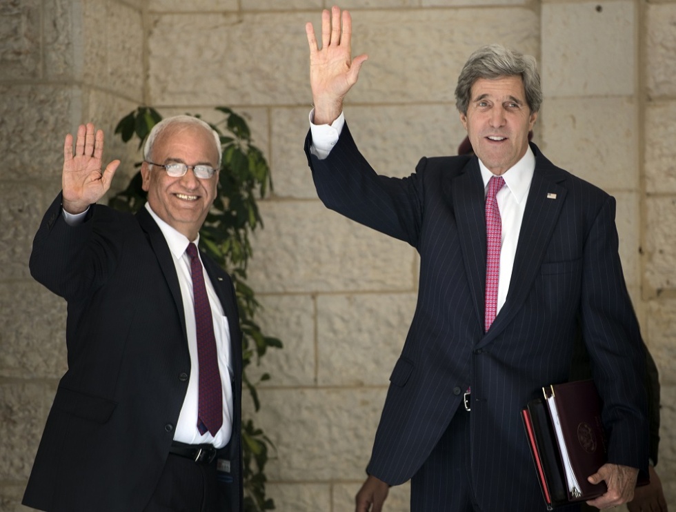 Then-US Secretary of State John Kerry (right) with Palestinian negotiator Saeb Erekat at the presidential compound in the West Bank city of Ramallah in January 2014