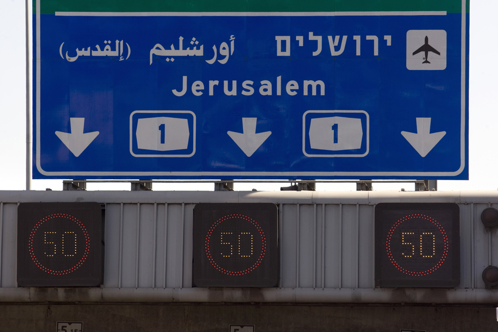A sign in Tel Aviv shows directions for Jerusalem in English, Hebrew and Arabic, with the Arabic signage prominently reading ‘Yerushalayim’ instead of the Arabic name Al-Quds (AFP)
