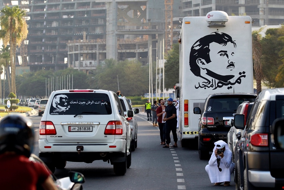 Painting depicting Qatar’s Emir Tamim Bin Hamad al-Thani splashed on bus in Doha (Reuters)