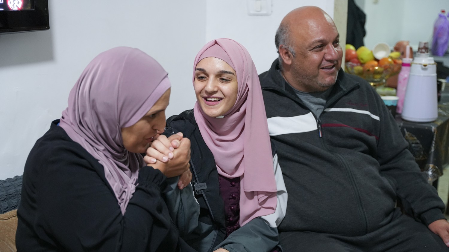 Malak Sulaiman, a Palestinian woman who was imprisoned at the age of 16, sits with her family after being freed on Friday.