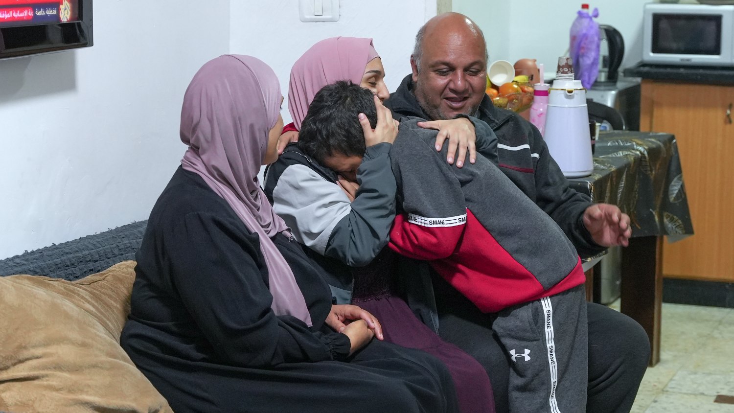 Malak Sulaiman, a Palestinian woman who was arrested and put in Israeli detention at 16 years old, sits with her family after being released on Friday.