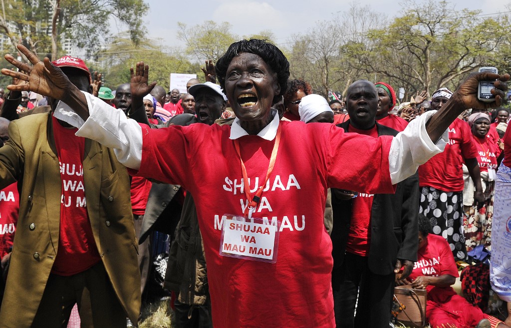 Members of the Mau Mau veterans’ association sing and dance in 2015 during the unveiling of a memorial dedicated to victims of the British massacre in the 1950s (AFP)