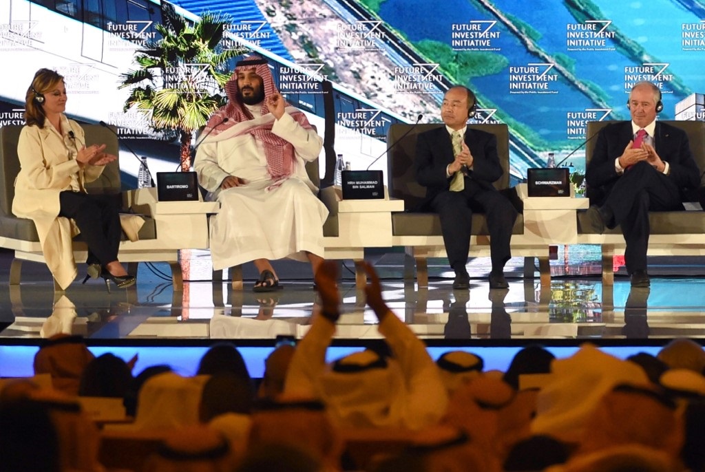 Saudi Crown Prince Mohammed bin Salman, US journalist Maria Bartirom, Masayoshi Son, CEO of SoftBank and Stephen Shwarzman, Blackstone Group CEO speak in Riyadh in October 2017 (AFP)