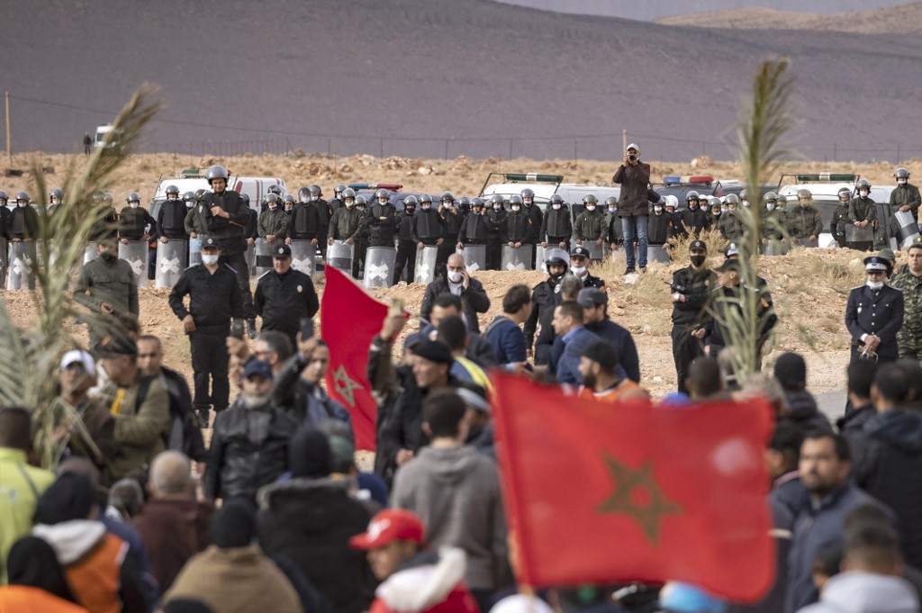 Moroccan security forces stand guard as farmers protest in Figuig on 18 March 2021 (AFP)