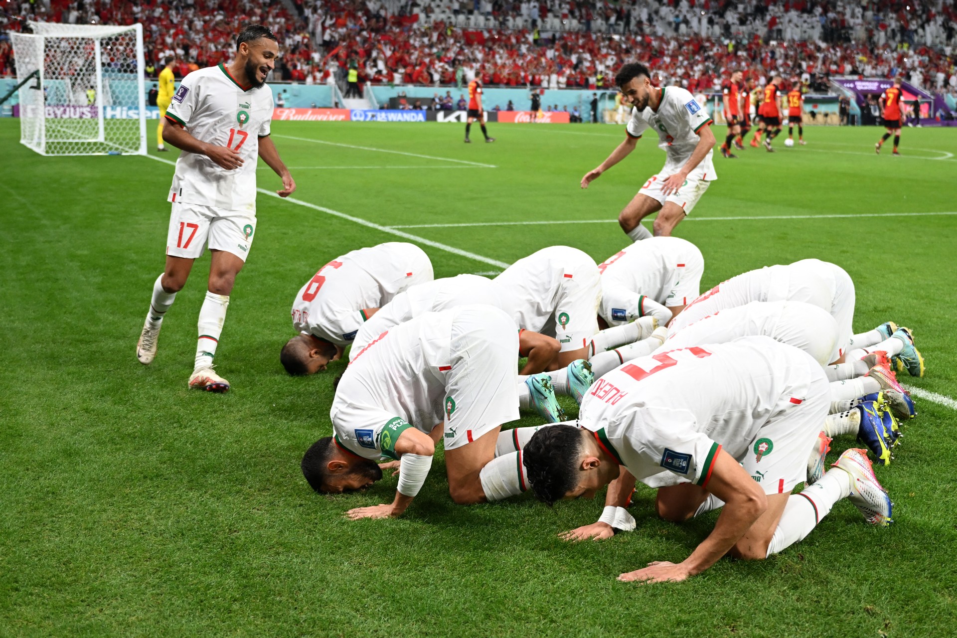 morocco players prostrate celebration belgium 