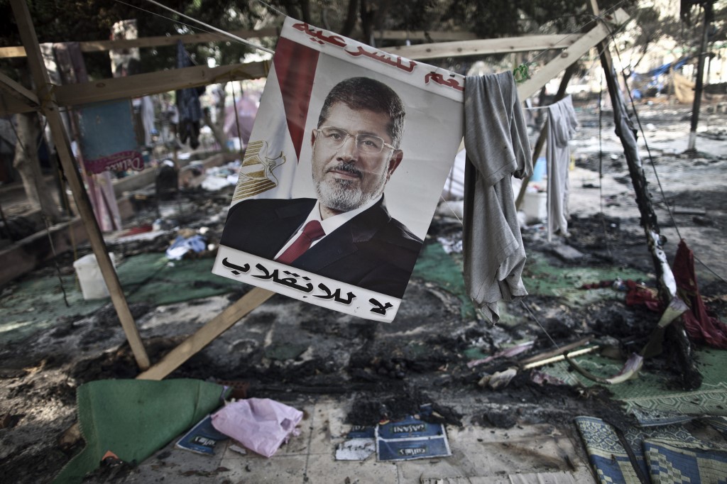 A picture of former Egyptian President Mohamed Morsi hangs in Rabaa Square in 2013 (AFP)