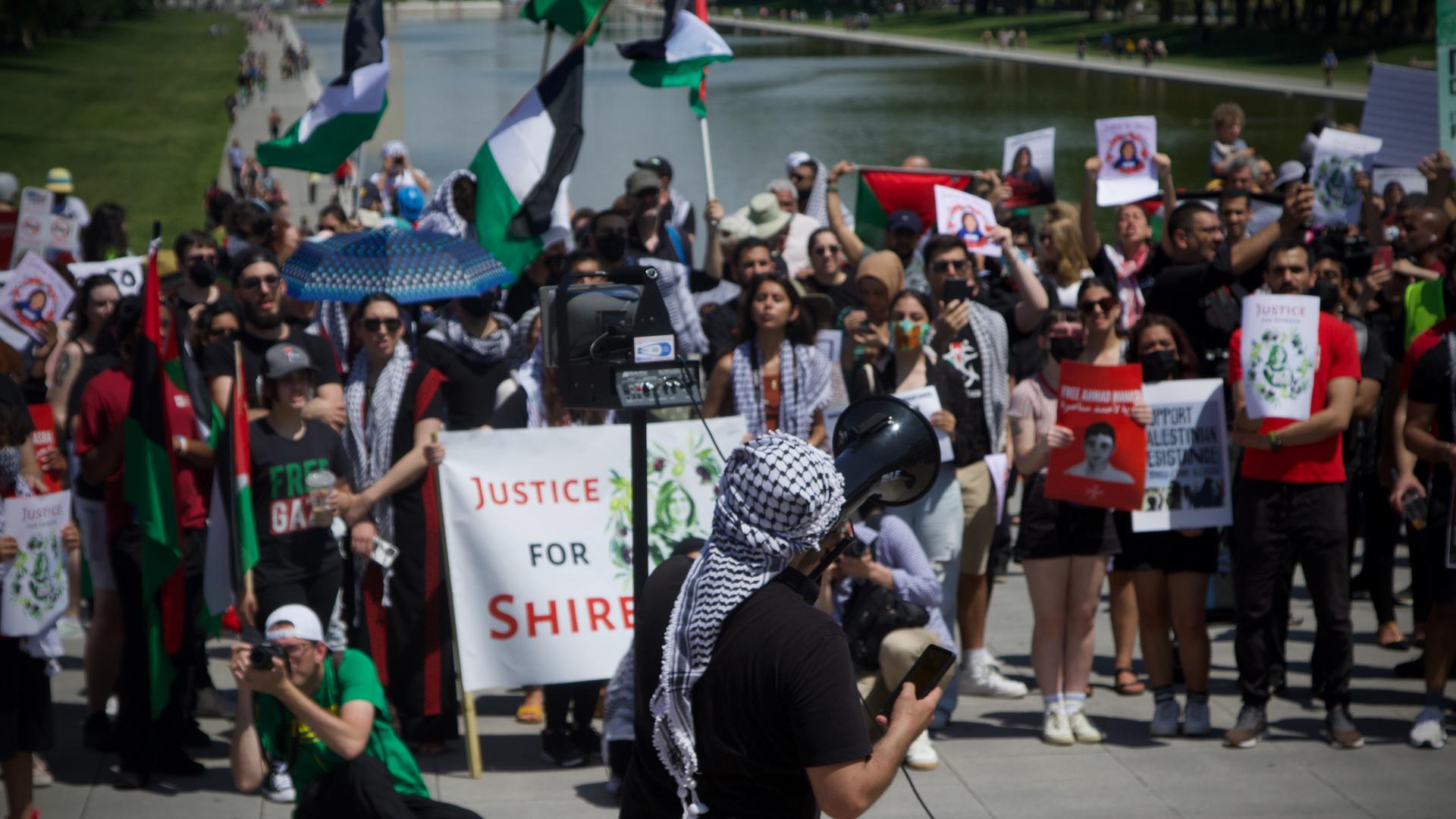 Taher Herzallah of American Muslims for Palestine speaks to a crowd of demonstrators at the Nakba rally in Washington on 15 May 2022.