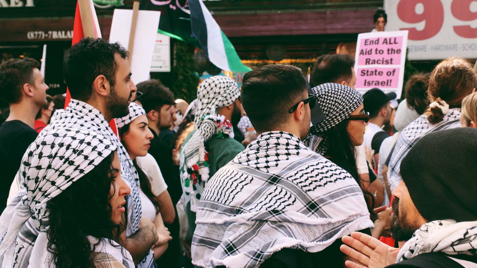Protesters in Brooklyn, New York wearing the traditional Palestinian keffiyeh (Zainab Iqbal/MEE)