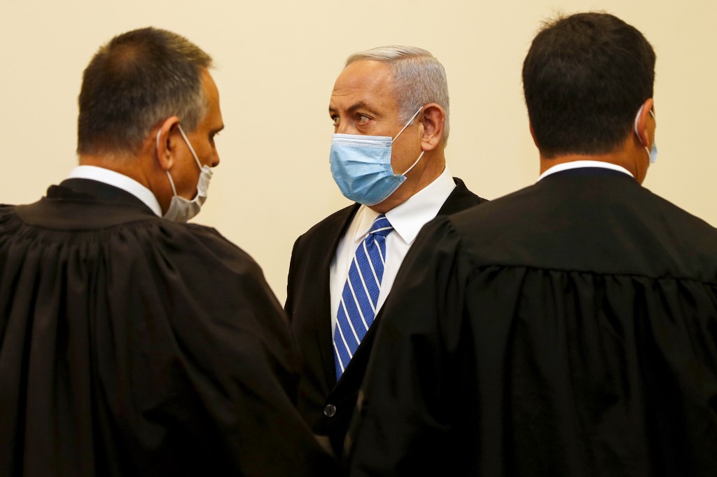 Netanyahu is pictured inside a Jerusalem courtroom as his corruption trial opens on 24 May (AFP)