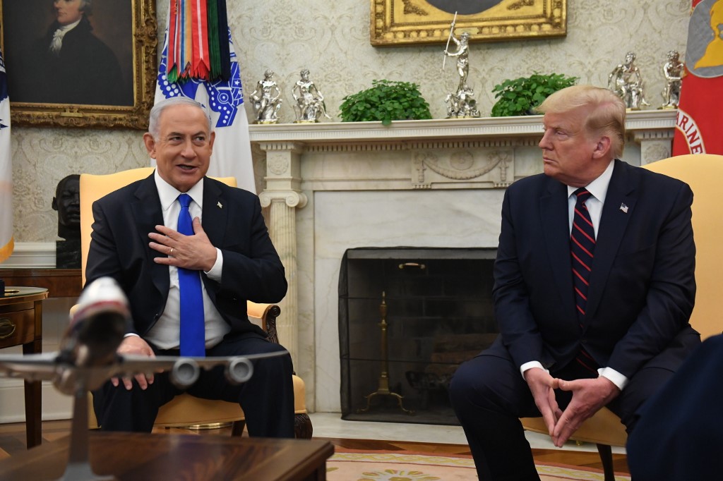 US President Donald Trump watches as Israeli Prime Minister Benjamin Netanyahu speaks during a meeting in Washington on 15 September (AFP)