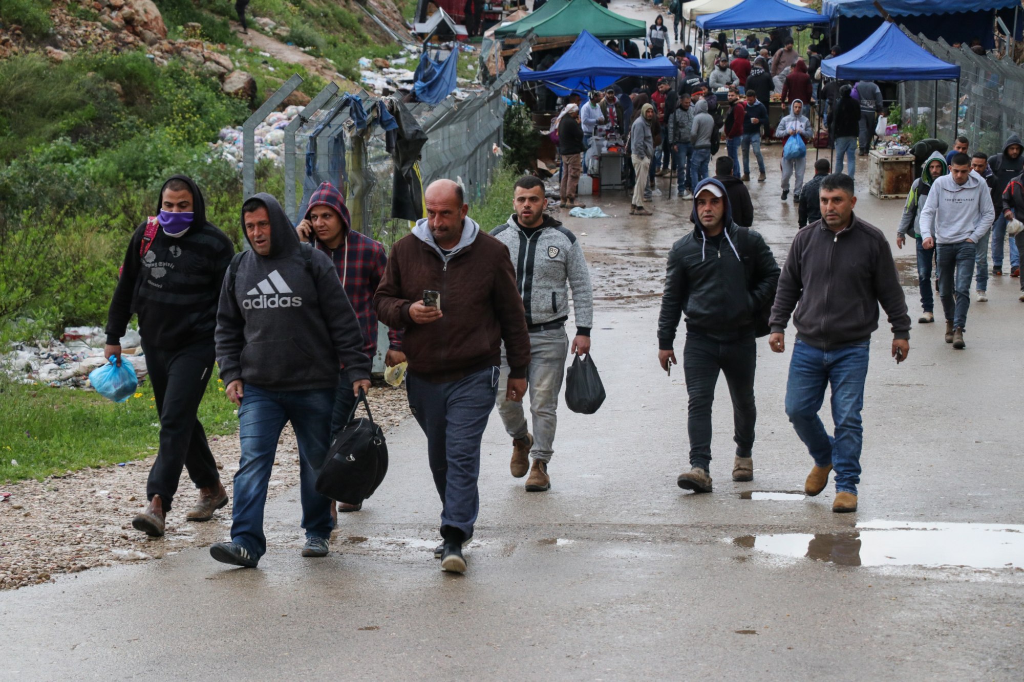 Palestinian labourers head to the Nilin checkpoint on 18 March, as Israel exceptionally allowed workers to stay overnight in the country (MEE/Mohammad Abu Zaid)