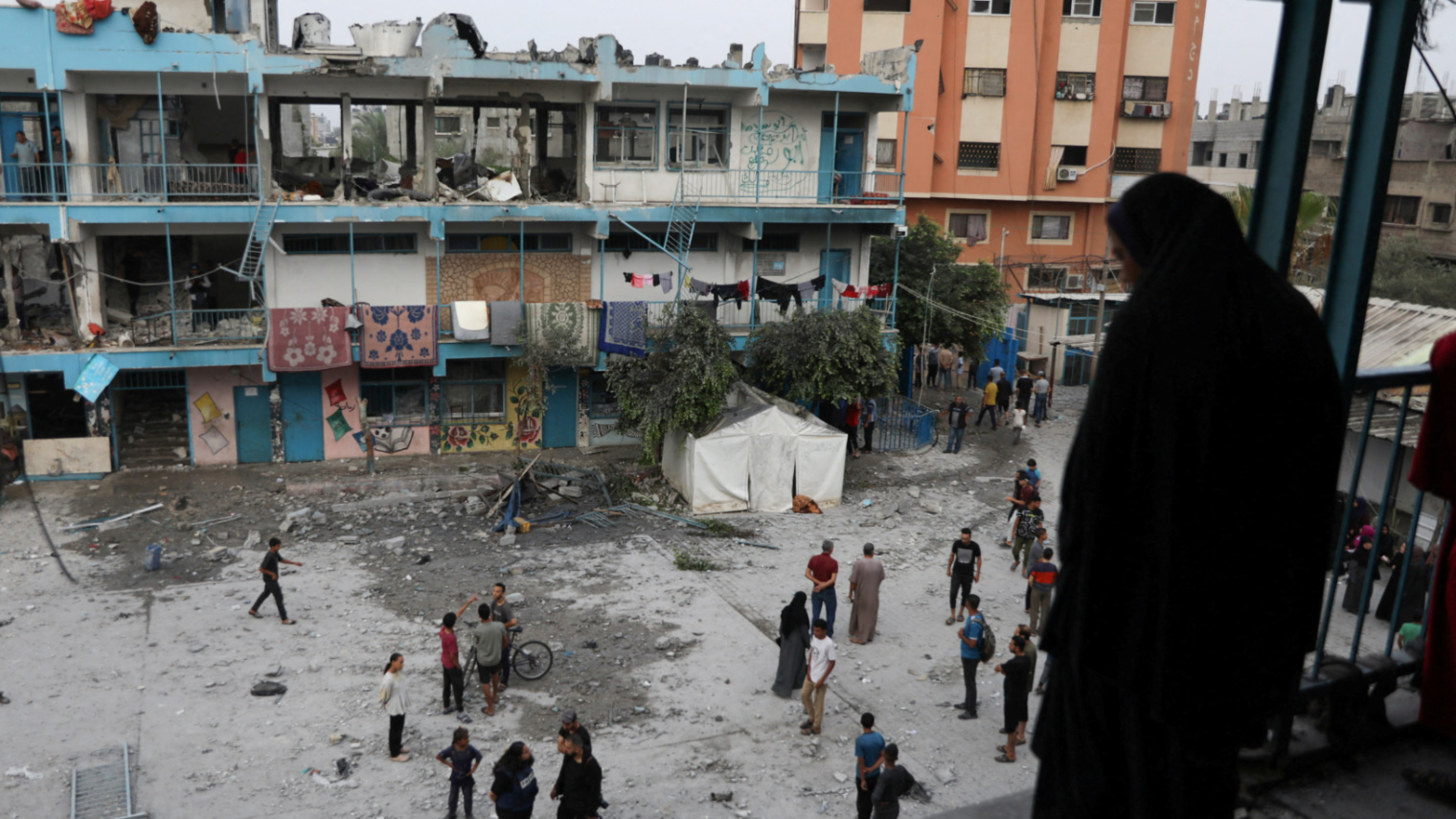 Palestinians inspect the site of an Israeli strike on an Unrwa school in Nuseirat, central Gaza on 6 June 2024 (Reuters/Abed Khaled)