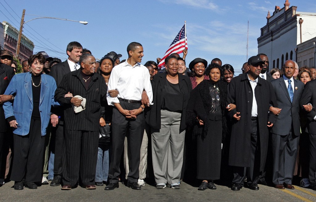 Obama poses for the media while marching in Selma, Alabama, in 2007 (AFP)