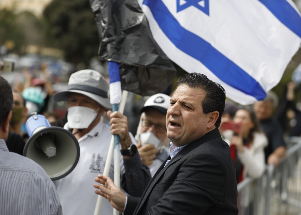 Joint List leader Ayman Odeh attends a protest outside the Knesset in Jerusalem on 23 March (AFP)