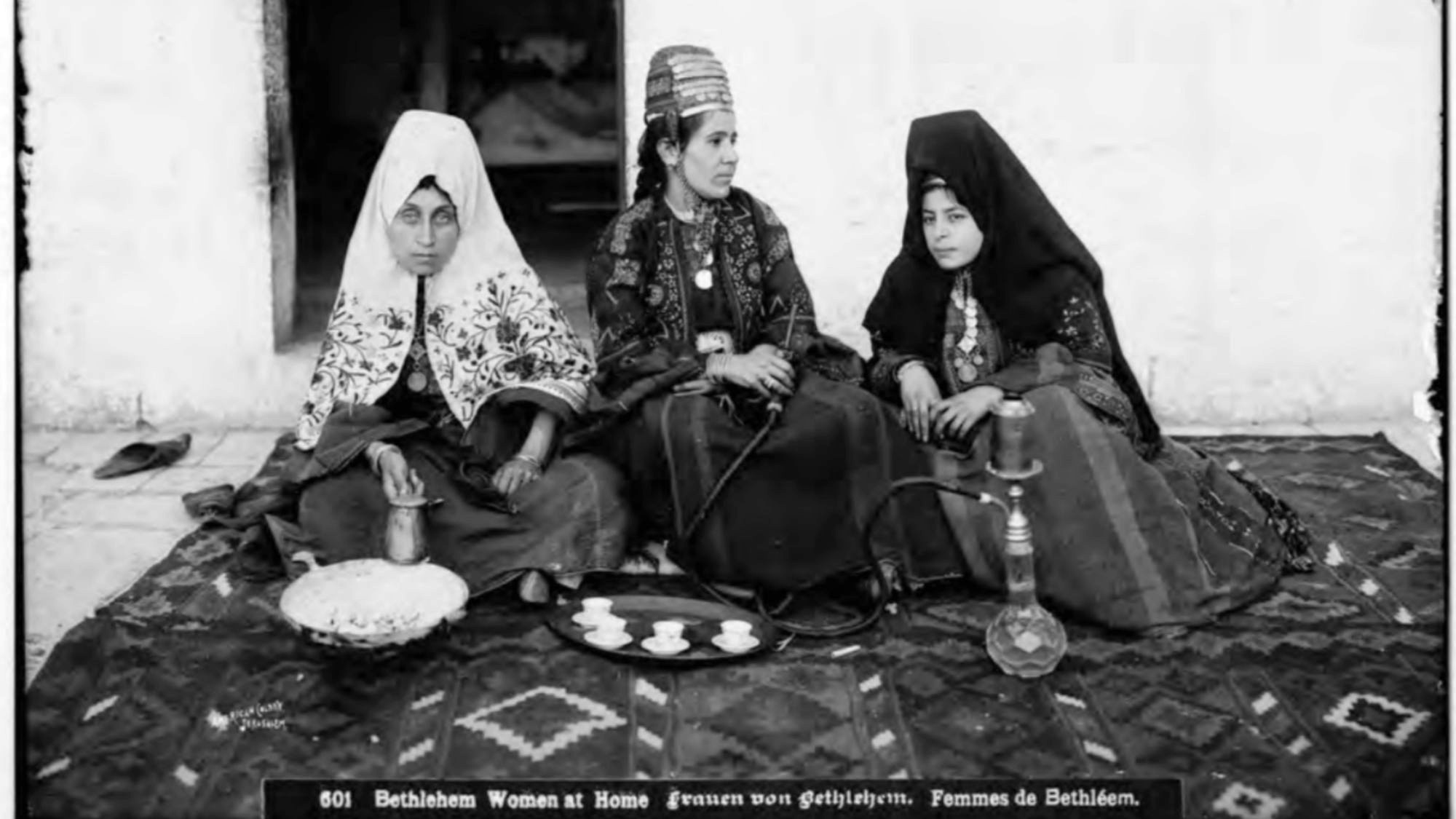 Three Bethlehem women sitting, smoking hookah, and drinking coffee in a private residence, 1898–1914 (MEE/Haymarket)