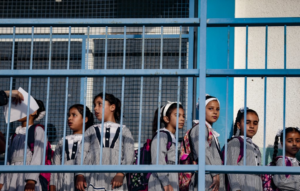 Palestinian students gather at a UN-run school in Jabalia refugee camp on 8 August (AFP)