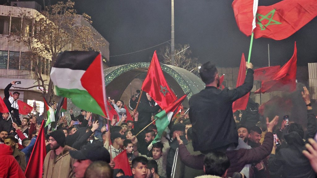 Palestinian football fans react as they watch the semi-final match between Morocco and France, in the occupied West Bank city of Hebron, on 14 December 2022 (AFP)