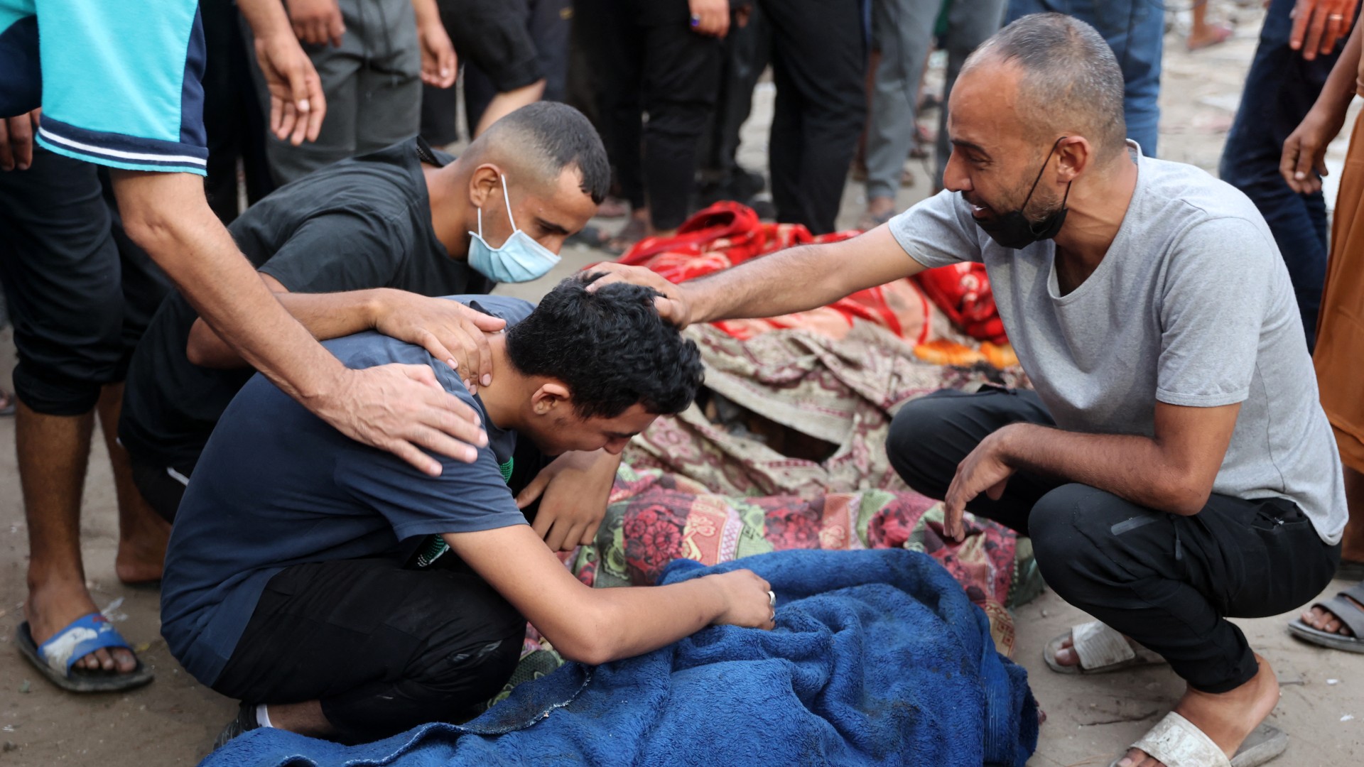 Palestinians mourn after a school used by displaced people as a temporary shelter in Gaza City was hit by Israeli strikes on 10 August, 2024 (Omar al-Qattaa/AFP)