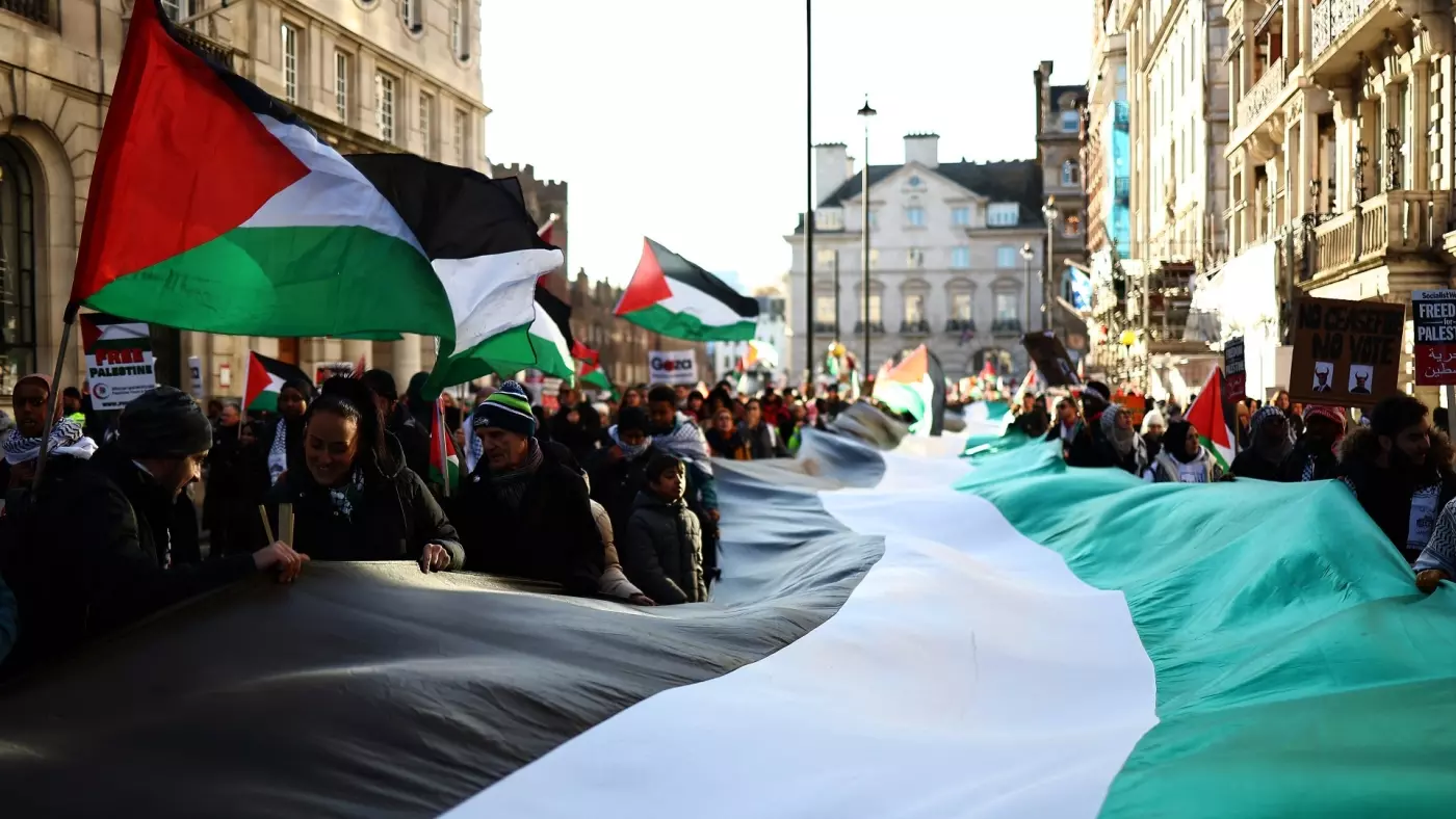 Pro-Palestinian protesters rally in London to demand a ceasefire on 25 November (AFP)