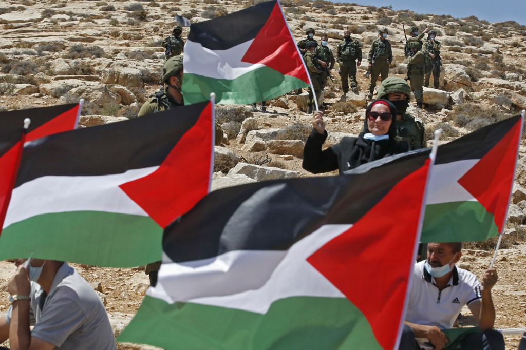 Palestinians protest Israeli settlement-building activities near Yatta on 21 August (AFP)