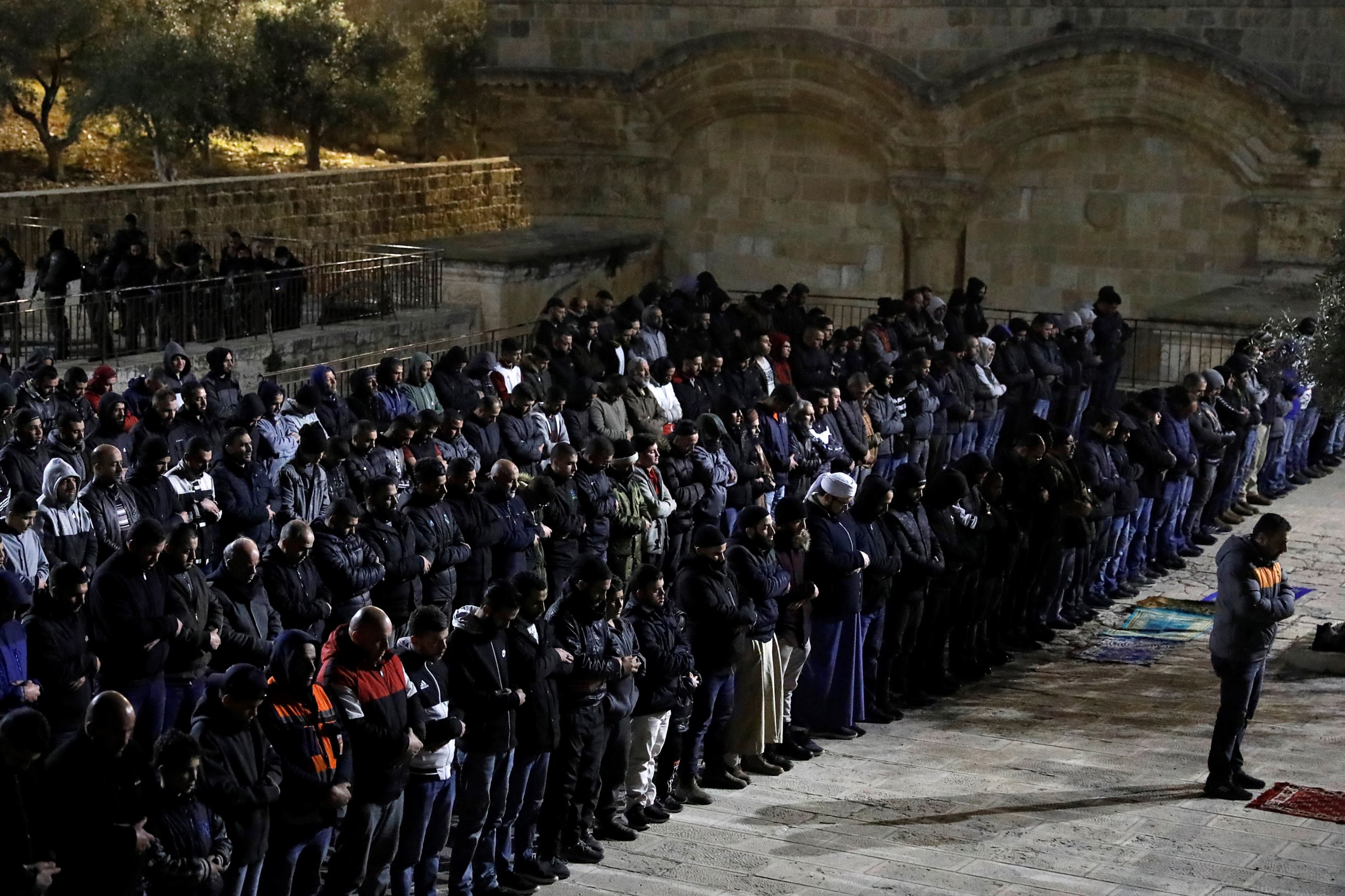 Palestinians pray near al-Rahmeh Gate in the Al-Aqsa mosque compound in Jerusalem on 20 February 2019 (AFP)