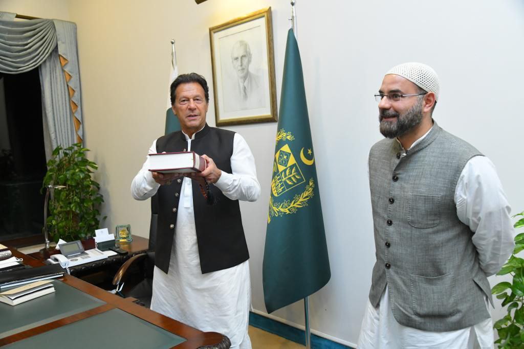Former Prime Minister of Pakistan Imran Khan holding a copy of Nuh Keller's translation of the Quran, the Quran Unbound, which he completed after 17 years (Supplied)