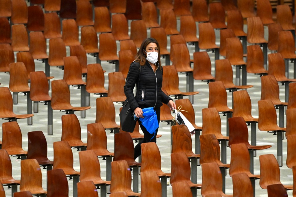 A woman arrives for Pope Francis’ general audience at the Vatican on 14 October (AFP)