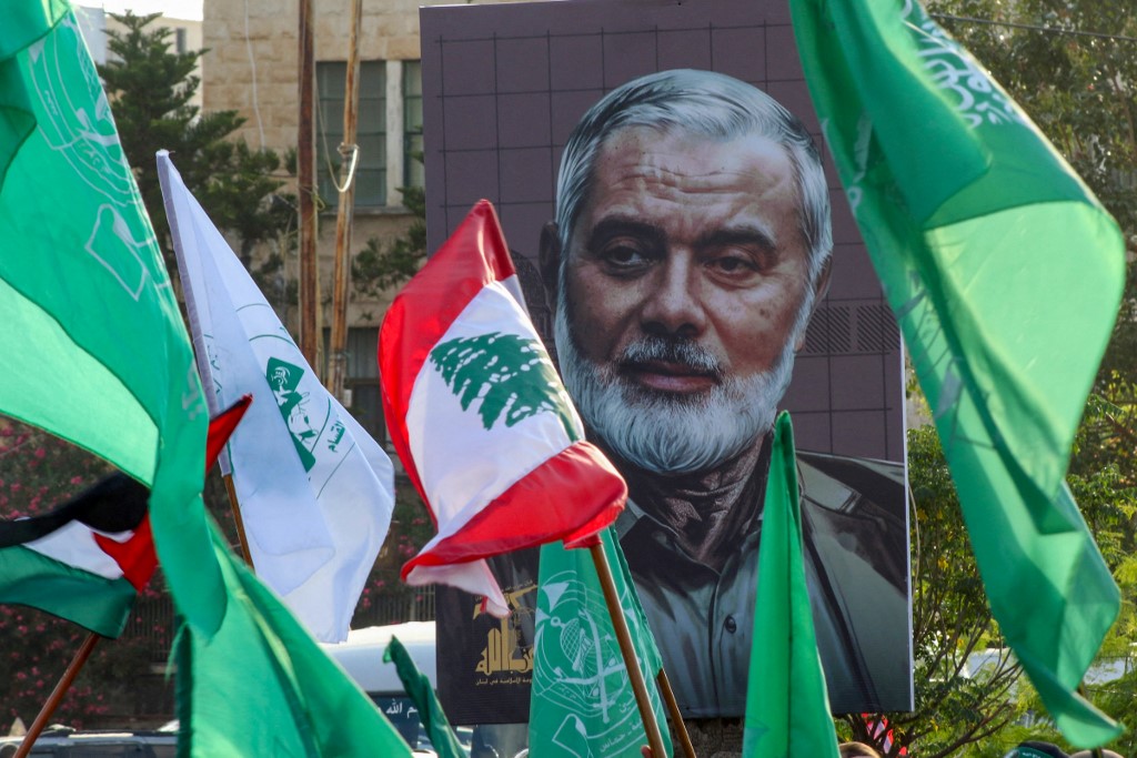 A portrait of slain Hamas leader Ismail Haniyeh is displayed during a demonstration denouncing his killing in the Lebanese coastal city of Sidon, 2 August 2024 (Mahmoud Zayyat/AFP)