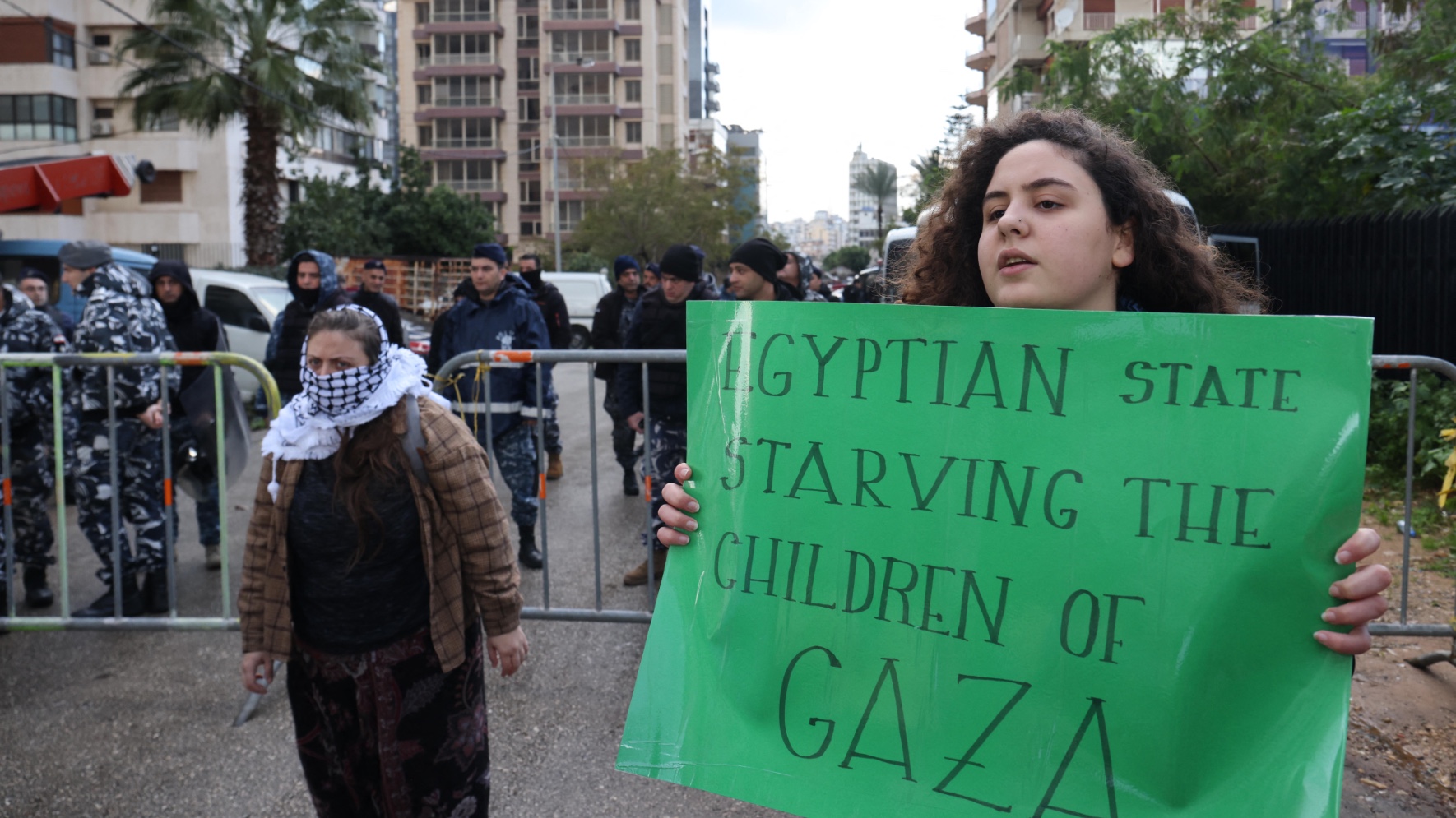 Lebanese activists block the road leading to the Egyptian embassy in Beirut in protest against the closure of the Rafah crossing between Egypt and the Gaza Strip, on 19 February 2024 (Anwar Amro/AFP)