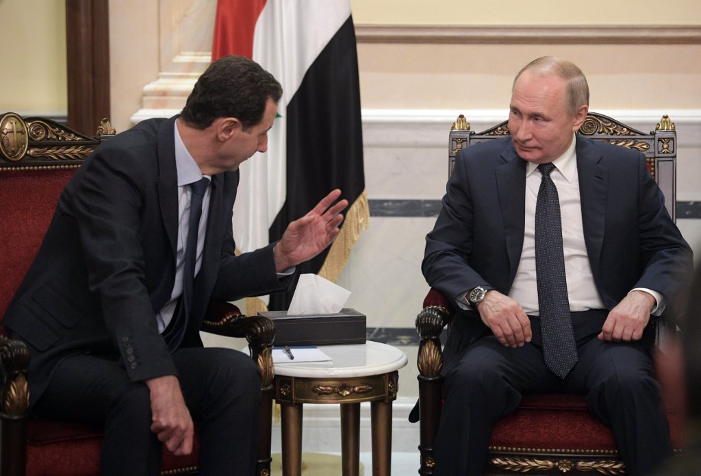 Putin meets Syrian President Bashar al-Assad in Damascus on 7 January (AFP)