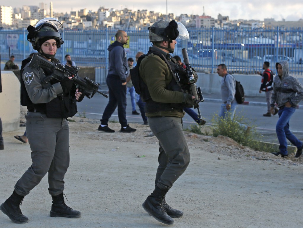 Israeli guards patrol the Qalandia checkpoint in the occupied West Bank on 10 May (AFP)
