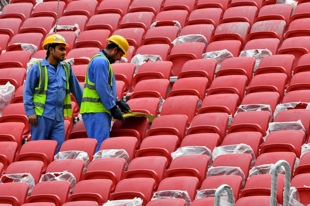 Construction workers are seen inside al-Bayt Stadium in Doha in December 2019 (AFP)
