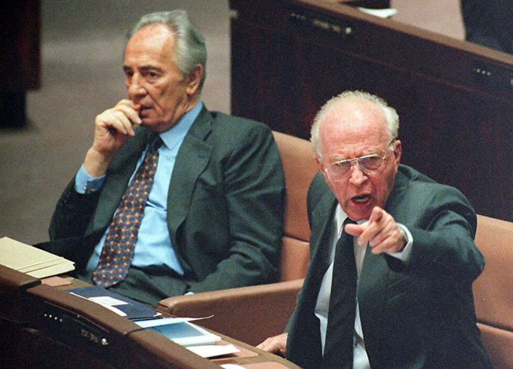 A picture taken on October 6, 1995 shows late Israeli Prime Minister Yitzhak Rabin (R) and then Foreign Minister Shimon Peres attending a Knesset (Israeli parliament) session in Jerusalem.