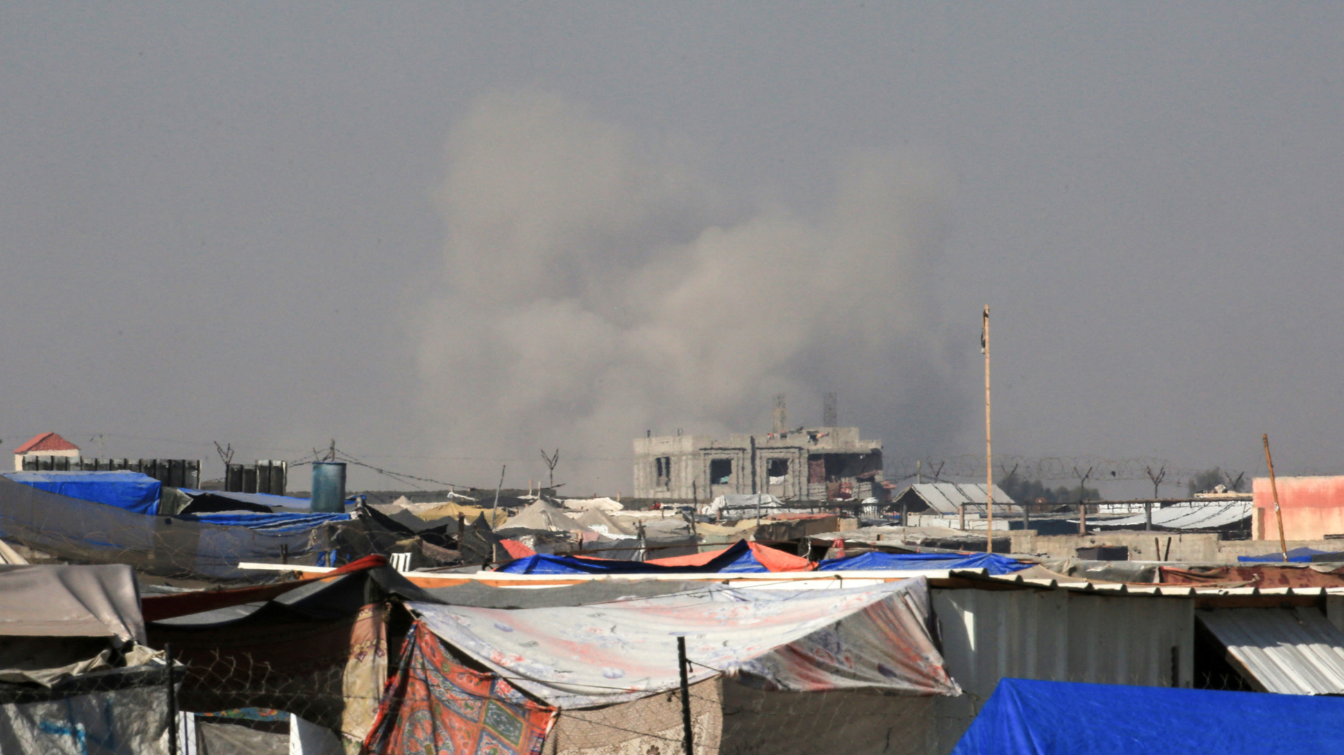 Smoke rises following an Israeli strike on Rafah, southern Gaza, as seen from a camp for displaced people in Khan Younis on 21 June 2024 (Eyad Baba/AFP)