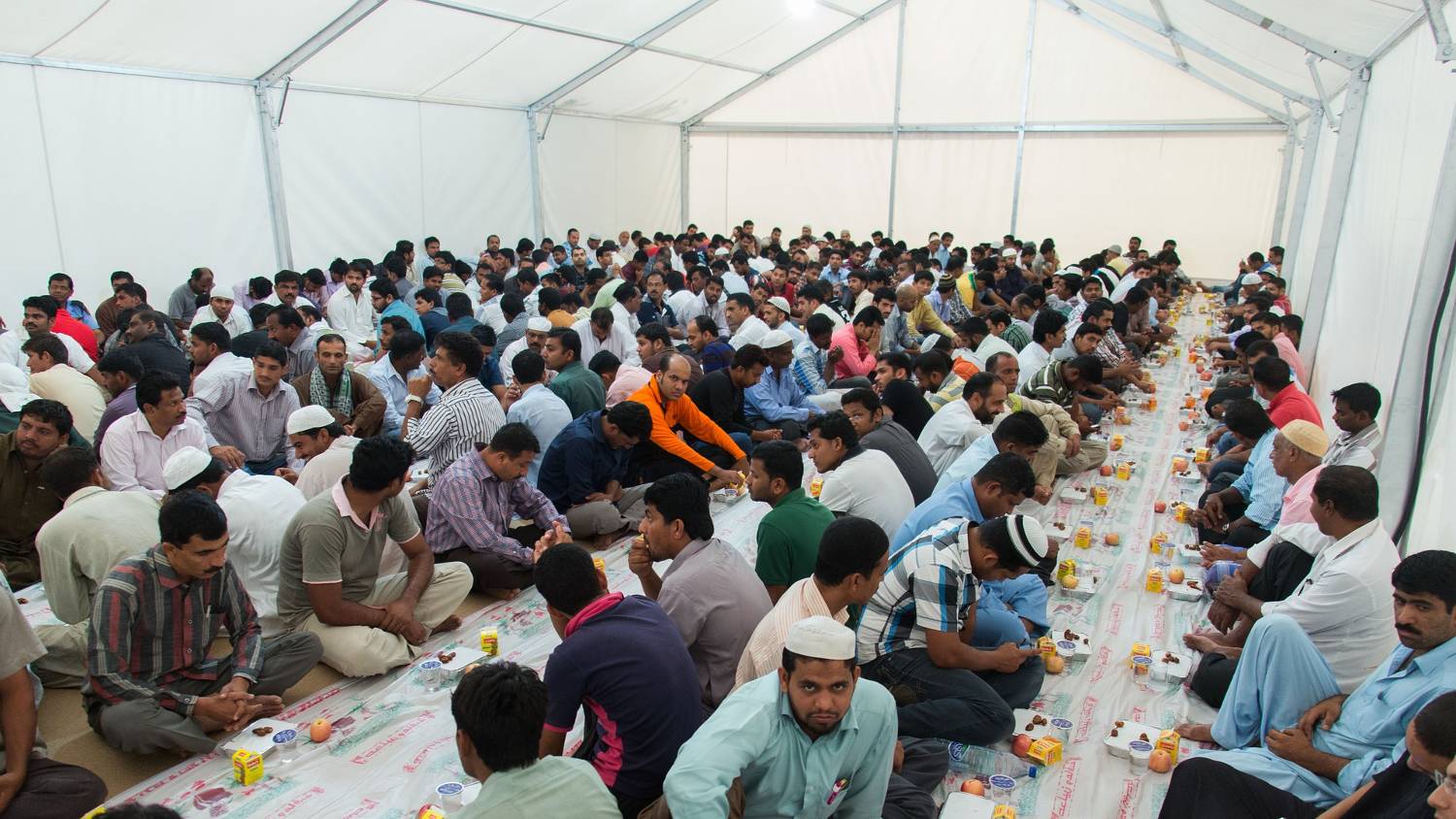 Tents are often set up in large open spaces to offer free meals to migrant workers during the month of Ramadan (CC/Ahmad Ardity)