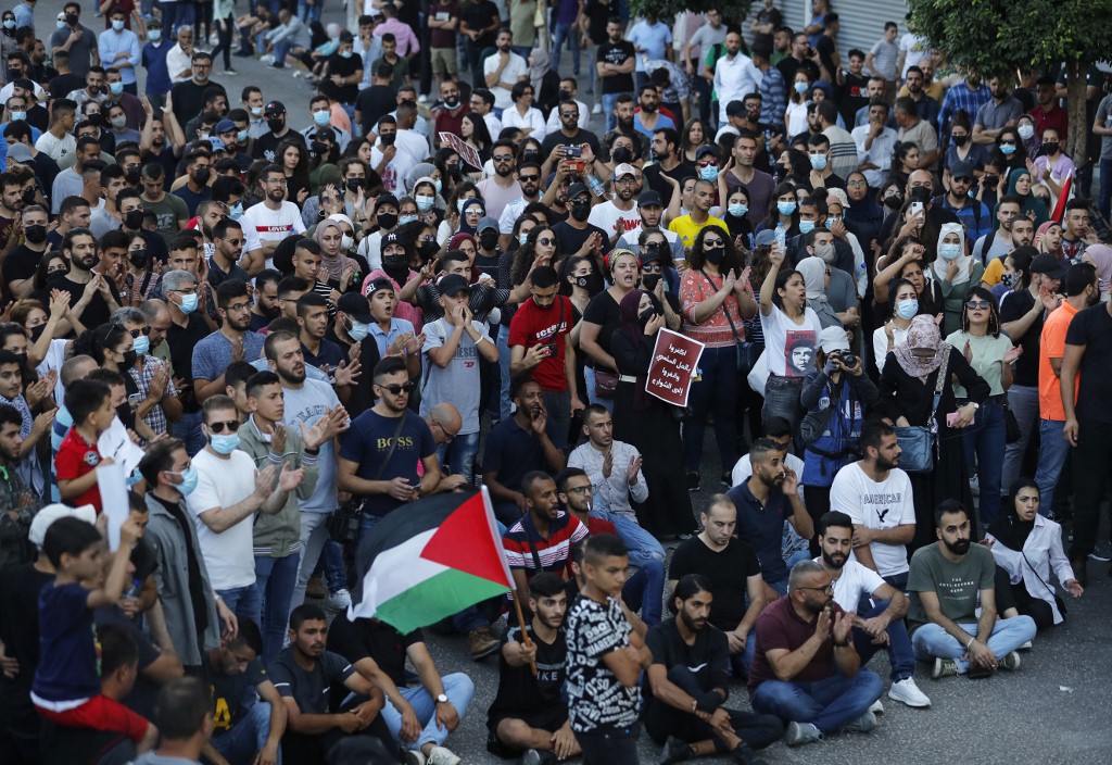 Palestinians hold a rally in Ramallah, in the occupied West Bank, on 3 July 2021 (AFP)