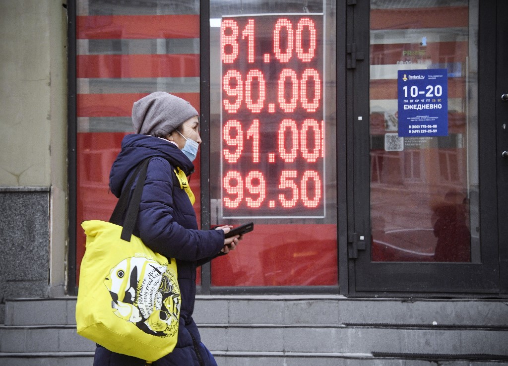 A woman walks past a currency exchange office in Moscow on 24 February 2022 (AFP)