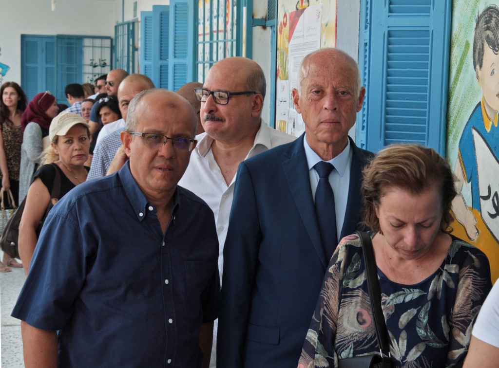 Saied waits to cast his ballot at a polling station in Tunis on 15 September (AFP)