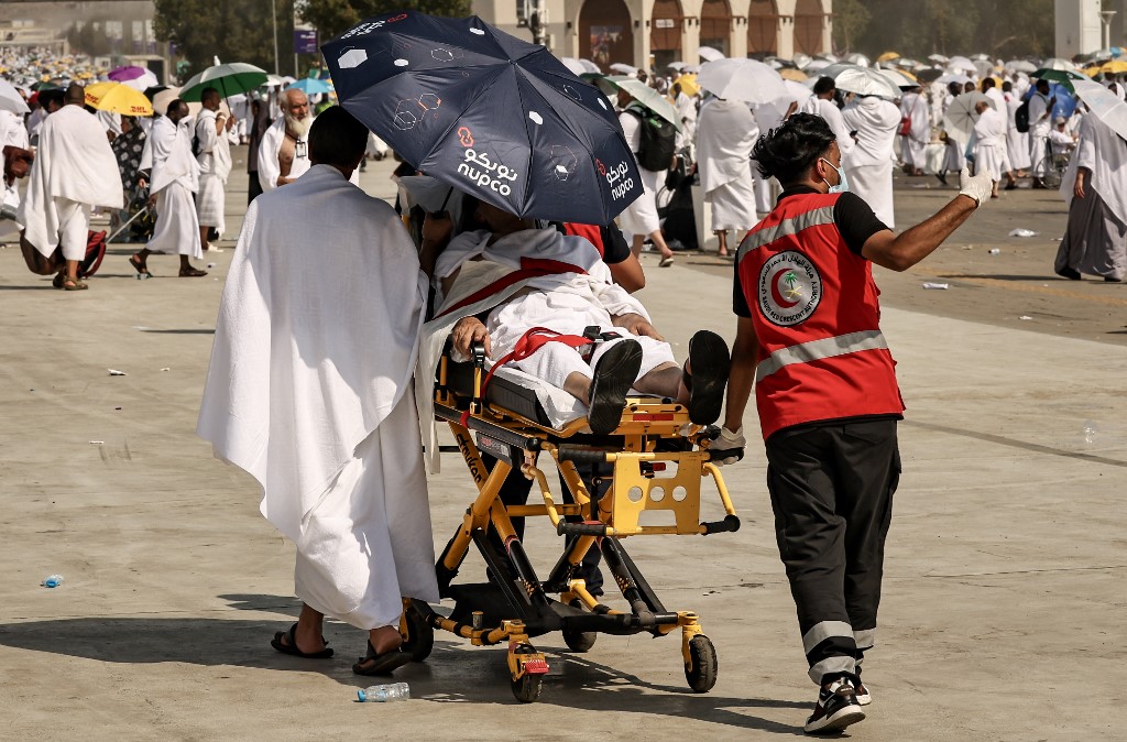 Medical team members evacuate a Muslim pilgrim, affected by the soarching heat, at the base of Mount Arafat, also known as Jabal al-Rahma or Mount of Mercy, during the annual hajj pilgrimage on June 15, 2024. 