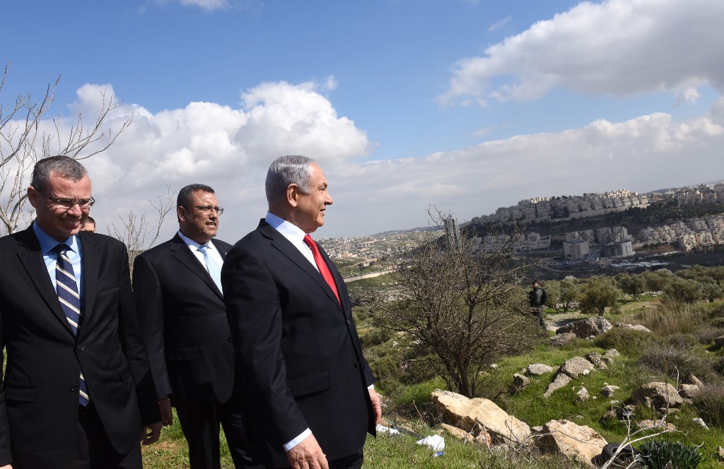 Netanyahu, looking over the Israeli settlement of Har Homa on 20 February, announced plans to build thousands of new homes for Jewish settlers in annexed East Jerusalem (AFP)