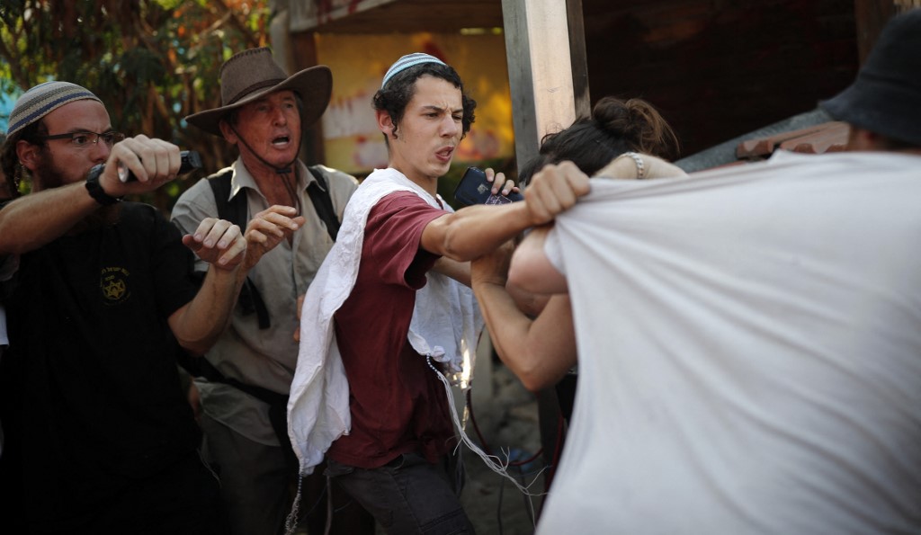 Jewish settlers clash with Peace Now activists in Sheikh Jarrah, Jerusalem, in 2017 (AFP)