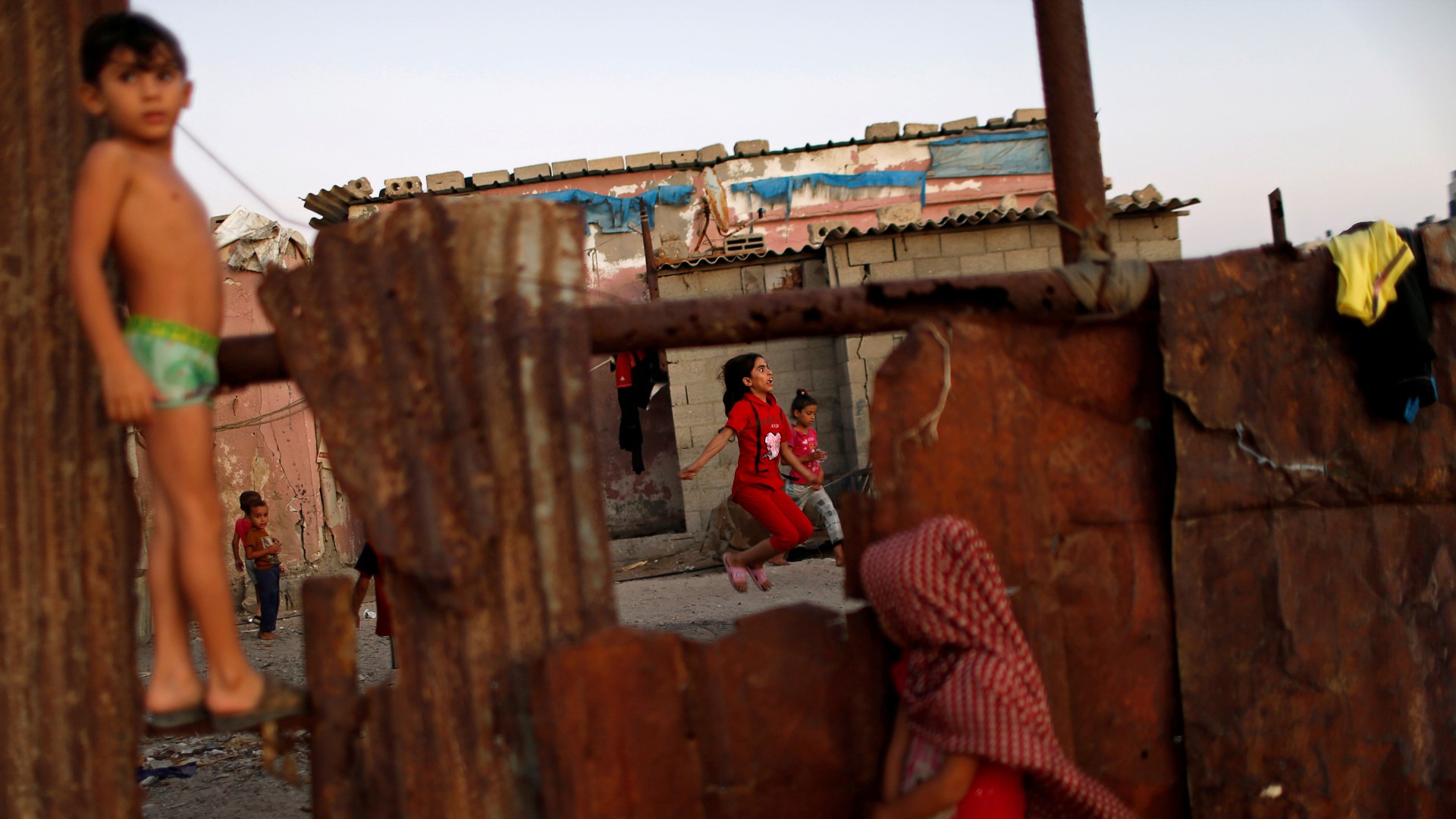 A Palestinian girl plays with a skipping rope outside her family house at al-Shati refugee camp in Gaza City, 16 September, 2019 (Reuters/Mohammed Salem)