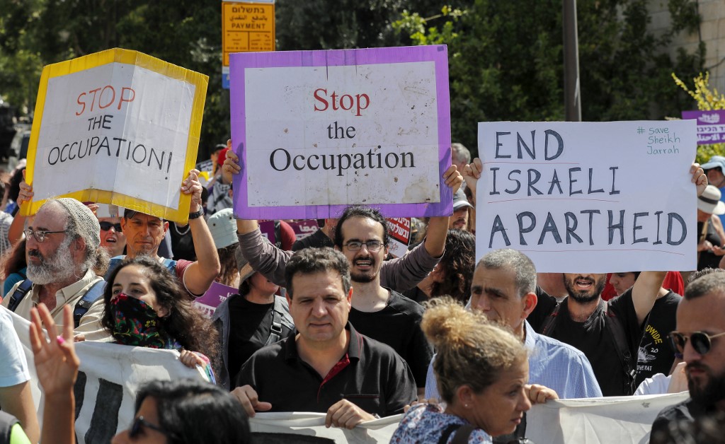 Activists protest against Israeli occupation near Sheikh Jarrah on 11 June 2021 (AFP)