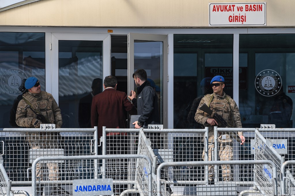 Turkish soldiers stand guard as two men enter the Silivri Prison and Courthouse complex in Silivri, near Istanbul on 18 February 2020 (AFP)