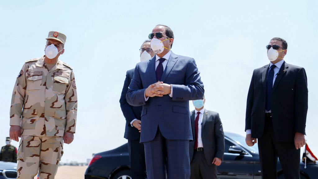 Egyptian President Abdel Fattah al-Sisi wears a protective face mask while visiting a military base east of Cairo on 7 April (Egyptian Presidency/AFP)