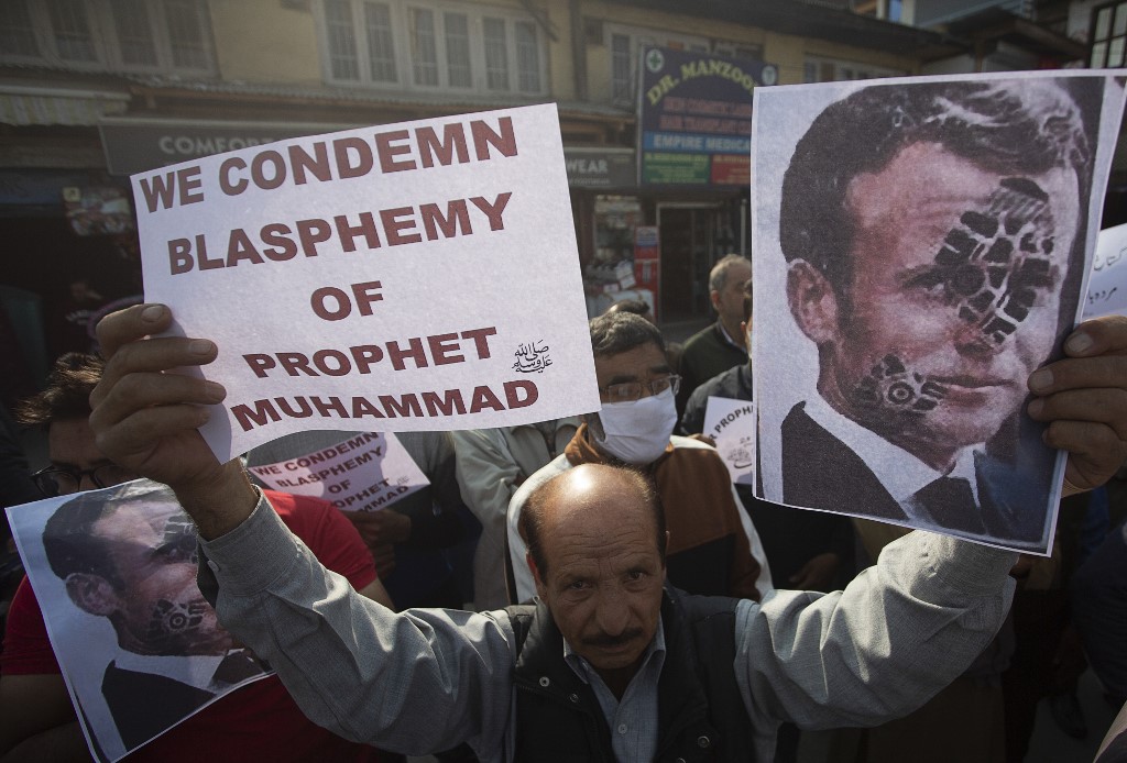 Protesters call for the boycott of French products in Srinagar on 30 October (AFP)