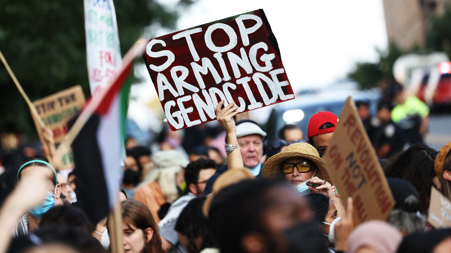 People gather to protest a campaign event for Democratic presidential candidate US Vice President Kamala Harris on 14 August in New York City (Michael M Santiago/Getty Images via AFP)