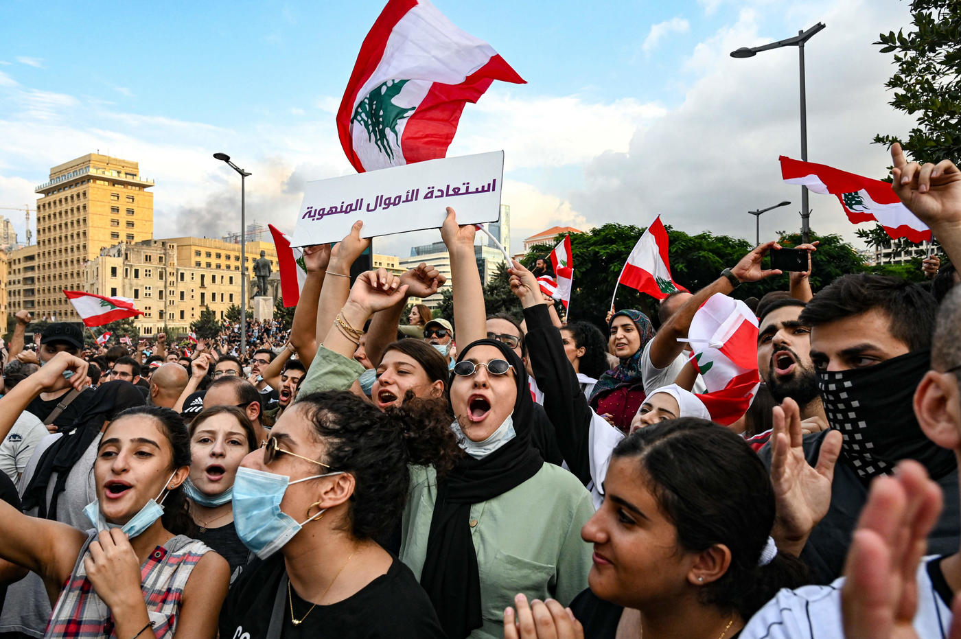 Young protesters chant together in Riad al-Solh Square, Beirut in October 2019 (AFP)