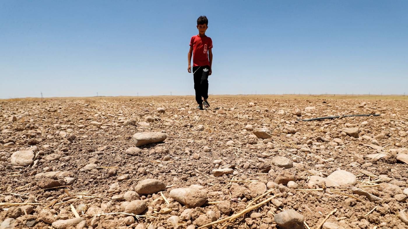 Iraq-dried-field-drought-boy-june-2021-afp